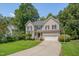 Charming two-story home featuring a well-maintained yard, two car garage, and lush landscaping at 106 Dairy Ct, Chapel Hill, NC 27516