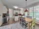 Bright open kitchen/dining space features white cabinets, an island, and lots of natural light at 106 Dairy Ct, Chapel Hill, NC 27516