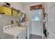 Bright laundry room with washer, dryer, wire shelving, and storage space at 106 Dairy Ct, Chapel Hill, NC 27516