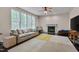 Bright living room featuring a cozy fireplace, natural light, and neutral colors at 106 Dairy Ct, Chapel Hill, NC 27516
