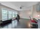 Bright living room with dark wood floors, ceiling fan, and lots of natural light at 106 Dairy Ct, Chapel Hill, NC 27516