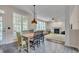 Well-lit dining room and living room with large windows and a fireplace at 106 Dairy Ct, Chapel Hill, NC 27516