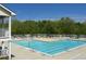 Relaxing community pool with lounge chairs and tables under a clear blue sky at 106 Dairy Ct, Chapel Hill, NC 27516