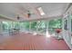 Relaxing screened porch with a ceiling fan, skylights, and an outdoor grill at 106 Dairy Ct, Chapel Hill, NC 27516