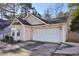 Tan house with a white garage door and landscaping at 109 Cabana Dr, Apex, NC 27539