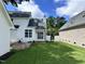 Spacious backyard featuring lush green grass and a brick patio area at 110 Ethans Glenn Ct, Cary, NC 27513