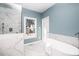 Spa-like bathroom with soaking tub, walk-in shower, and marble tile at 110 Ethans Glenn Ct, Cary, NC 27513