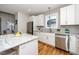 Modern kitchen with white cabinets, granite countertops, and stainless steel appliances at 110 Ethans Glenn Ct, Cary, NC 27513