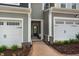 Inviting brick walkway leads to front entrance of townhome with attached garages at 111 Siebold St, Garner, NC 27529