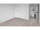 Neutral carpeted bedroom with a closet and doorway, providing ample space and storage at 112 1St St, Oxford, NC 27565