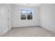 Bright bedroom with neutral carpet and large window providing ample natural light at 112 1St St, Oxford, NC 27565