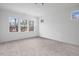 Sunlit bedroom with neutral carpet and large windows offering pleasant views at 112 1St St, Oxford, NC 27565