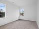Cozy bedroom with plush carpet, two windows letting in natural light, and neutral wall color at 112 1St St, Oxford, NC 27565