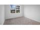 Bright, carpeted bedroom with large window overlooking neighborhood homes at 112 1St St, Oxford, NC 27565