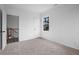 Spacious bedroom with plush carpet and bright view to the staircase, neutral wall color and trim at 112 1St St, Oxford, NC 27565
