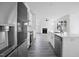 Open kitchen features modern appliances, sleek cabinetry, and views of the fireplace at 112 1St St, Oxford, NC 27565