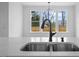 The spacious kitchen island sink boasts a matte black faucet and marble countertops at 112 1St St, Oxford, NC 27565