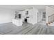 Island kitchen featuring stainless appliances, marble backsplash, and sleek, white cabinets at 112 1St St, Oxford, NC 27565