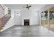 Inviting living room showcasing wood-look floors, a fireplace, and sliding glass doors to the outdoor deck at 112 1St St, Oxford, NC 27565