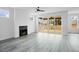Inviting living room showcasing wood-look floors, a fireplace, and sliding glass doors to the outdoor deck at 112 1St St, Oxford, NC 27565