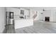 Open-concept kitchen with an island, stainless appliances, and fireplace creates a seamless flow for entertaining at 112 1St St, Oxford, NC 27565