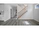 Spacious and bright living room featuring stairs, and wood-look flooring creating a modern and airy atmosphere at 112 1St St, Oxford, NC 27565