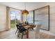 A dining room with a wood table, decorative lighting, and a view of a grassy yard at 116 Kobus Ct, Garner, NC 27529