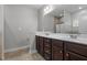 Double vanity bathroom with dark brown cabinets and marble countertops at 116 Saddle Ln, Lillington, NC 27546