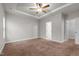 Bright bedroom with plush carpeting, and access to bathroom and closet at 116 Saddle Ln, Lillington, NC 27546