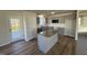 Modern kitchen with gray cabinets, granite island, and stainless steel appliances at 120 Magnolia Run Way, Benson, NC 27504