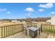 Deck with fire pit and seating, overlooking a wooded area and neighborhood at 120 Starry Sky Dr, Benson, NC 27504