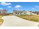 House with driveway and partial view of neighboring home at 120 Starry Sky Dr, Benson, NC 27504
