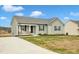 Single-story house with gray siding, a porch, and a driveway at 120 Starry Sky Dr, Benson, NC 27504