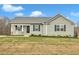 Single-story house with gray siding, a porch, and a driveway at 120 Starry Sky Dr, Benson, NC 27504