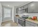Kitchen with grey cabinets, granite countertops and stainless steel appliances at 120 Starry Sky Dr, Benson, NC 27504