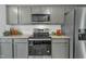 Modern kitchen features stainless steel appliances and granite countertops at 120 Starry Sky Dr, Benson, NC 27504