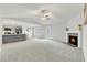 Open living space featuring a fireplace and kitchen with island at 120 Starry Sky Dr, Benson, NC 27504