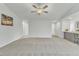 Spacious living room with vaulted ceiling, ceiling fan, and grey carpet at 120 Starry Sky Dr, Benson, NC 27504