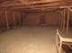Spacious unfinished attic with wood flooring and exposed beams, offering potential for storage or customization at 1200 Spring Valley Lake Rd, Henderson, NC 27536