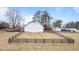 White barn on a grassy hill with a dark-stained fence at 1200 Spring Valley Lake Rd, Henderson, NC 27536