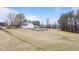 White barn on a grassy hillside with fencing at 1200 Spring Valley Lake Rd, Henderson, NC 27536