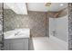 Bathroom featuring tub-shower, double vanity, and paisley wallpaper at 1200 Spring Valley Lake Rd, Henderson, NC 27536