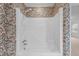 Bathtub and shower featuring paisley wallpaper and white tile flooring at 1200 Spring Valley Lake Rd, Henderson, NC 27536