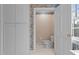 Bathroom featuring toilet, white cabinets and paisley wallpaper at 1200 Spring Valley Lake Rd, Henderson, NC 27536