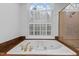 Bathroom with a soaking tub under an arched window and separate shower at 1200 Spring Valley Lake Rd, Henderson, NC 27536