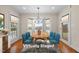Cozy dining room featuring a bay window, chandelier, and light-colored walls at 1200 Spring Valley Lake Rd, Henderson, NC 27536