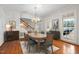 Formal dining room with hardwood floors, a chandelier, and a large window, perfect for entertaining at 1200 Spring Valley Lake Rd, Henderson, NC 27536