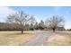 Long driveway lined with trees leading up to the property, offering privacy and a grand entrance at 1200 Spring Valley Lake Rd, Henderson, NC 27536
