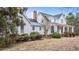 Charming exterior view of a white home featuring a covered porch and beautifully landscaped yard at 1200 Spring Valley Lake Rd, Henderson, NC 27536