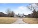 Stately home with large circular driveway and mature trees, set back from the road for added privacy at 1200 Spring Valley Lake Rd, Henderson, NC 27536